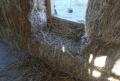 Straw bale home wall with window opening, the bales are rendered over forming a beautiful wall 




